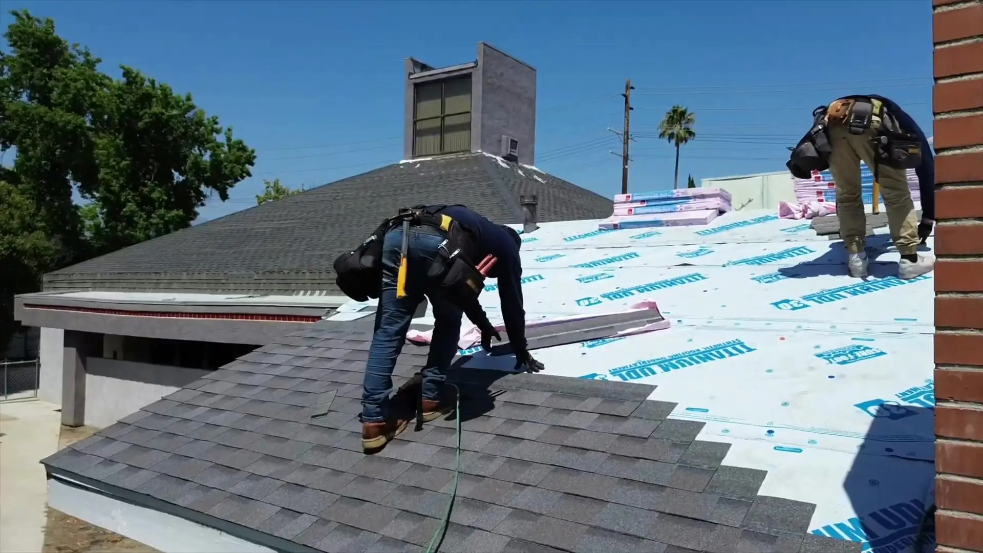 Final Touch Roofing crew installing composition shingles over new underlayment